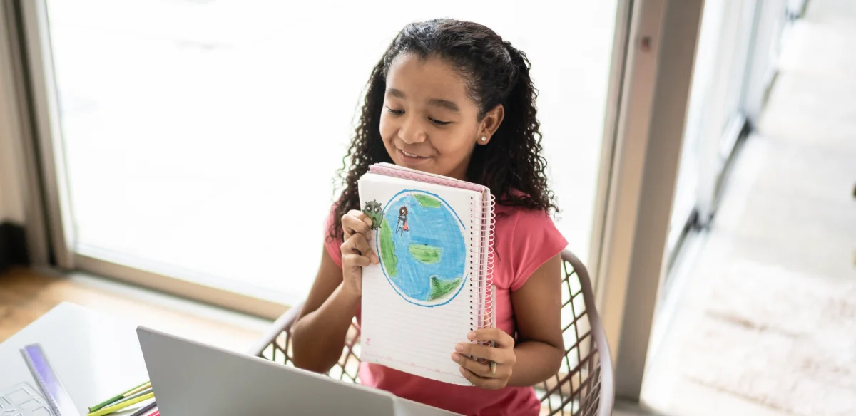 Elementary student showing a draw to her online class