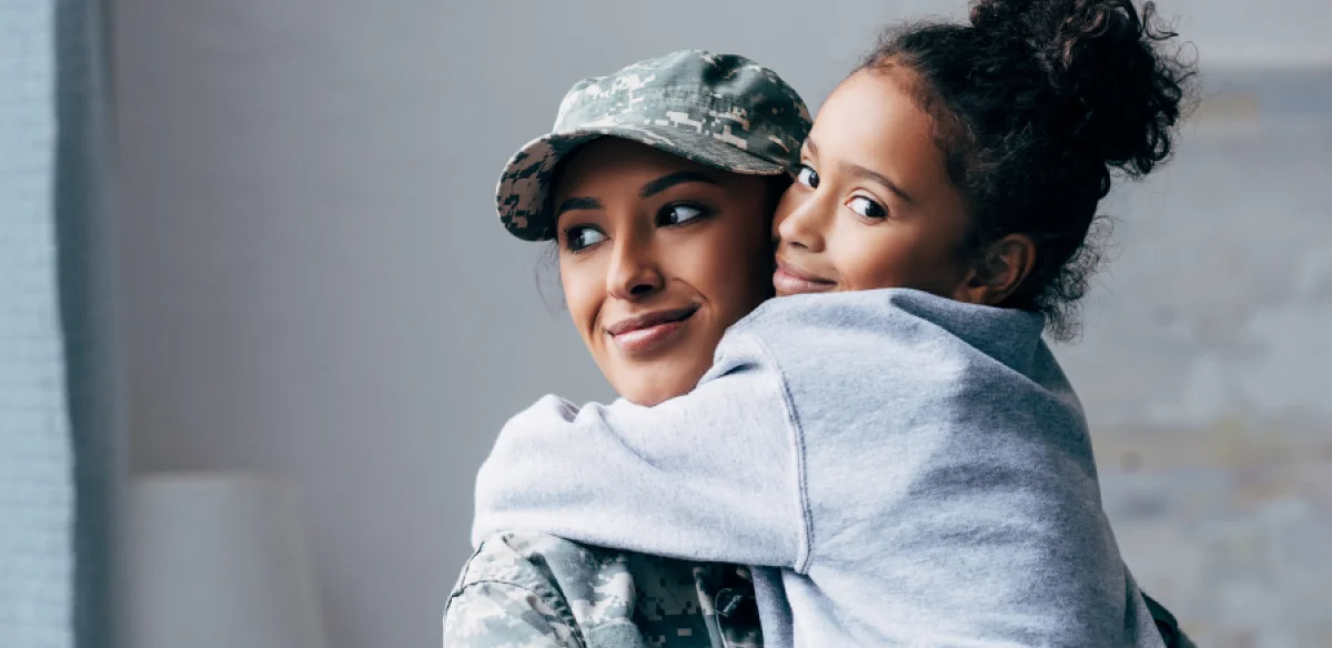 Military mother hugging her daugther